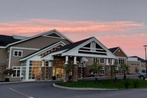 Covenant Living of Keene entrance with a sunset sky