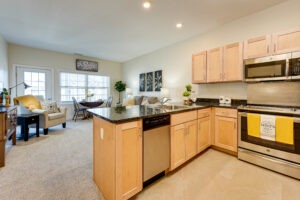 Interior of an apartment kitchen and living area with door to balcony