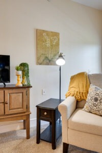 Close up of an apartment living area of a loveseat and floor lamp
