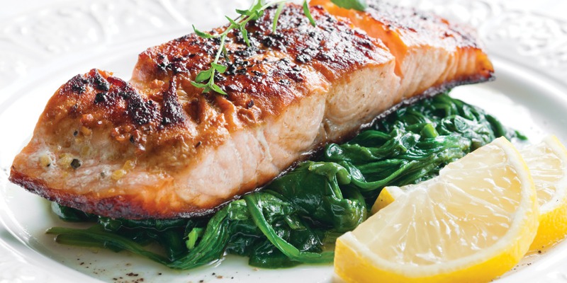grilled salmon on top of spinach