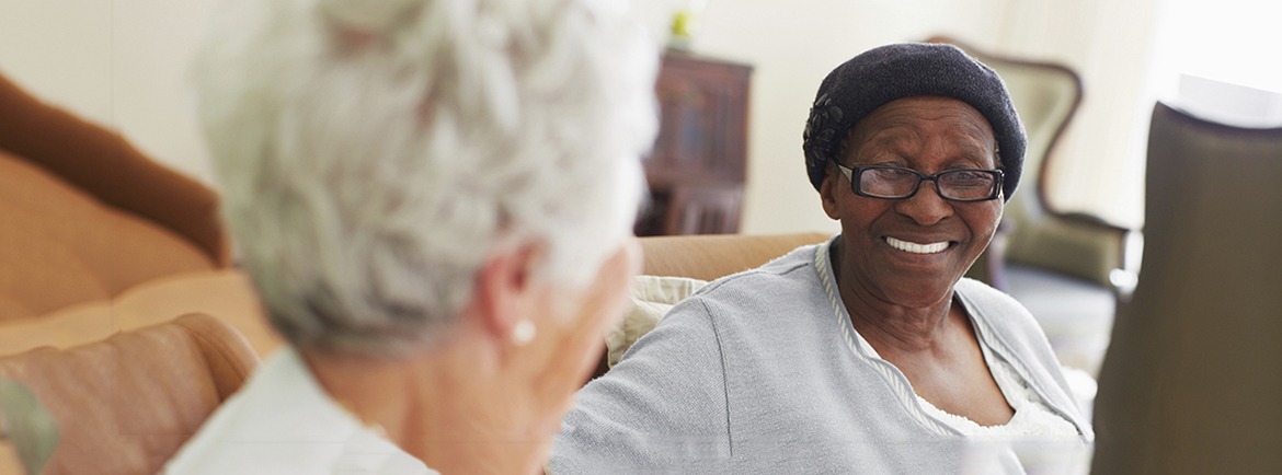 Two women smiling and chatting with eachother