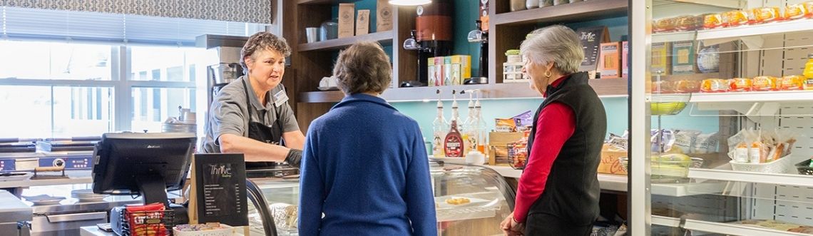 two women ordering food at a cafe